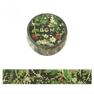 May include: A roll of decorative washi tape featuring a dark green background with a botanical design. The tape includes images of leaves, flowers, and the letters "BGM". A strip of the tape is shown below the roll, displaying the repeating pattern.
