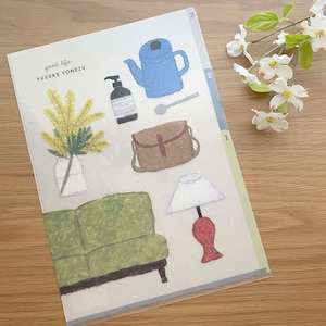 May include: A light blue teapot, a brown leather bag, a green sofa, a white lamp with a red base, a bottle of liquid soap, a spoon, and a vase with yellow flowers. The image has the text "good life" and "YUSUKE YONEZU" on it.