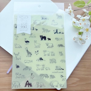 May include: A clear plastic sleeve containing a light green sheet with black line drawings of various animals. The sheet has Japanese text and the words "animal parade". The sleeve is on top of a white envelope.