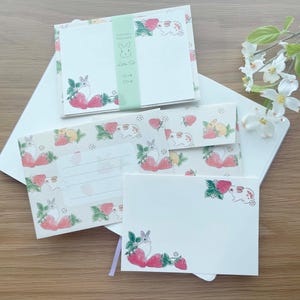 May include: A set of stationery featuring a cute bunny rabbit design with strawberries and flowers. The stationery includes envelopes and note cards.