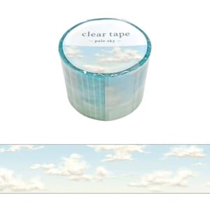May include: A roll of clear tape with a pale blue sky and white clouds design. The tape dispenser is labeled "clear tape - pale sky - "