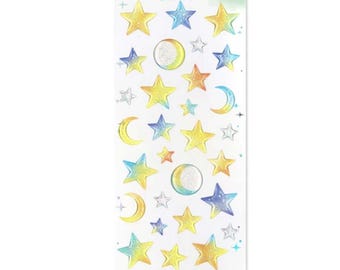 May include: A sheet of decorative stickers featuring celestial designs. The stickers include stars, moons, and circles in shades of yellow, blue, and silver. The text "DROP DROP" is printed at the top.