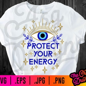 May include: White t-shirt with a blue evil eye design and gold stars. The text "Protect Your Energy" is written in blue below the eye.