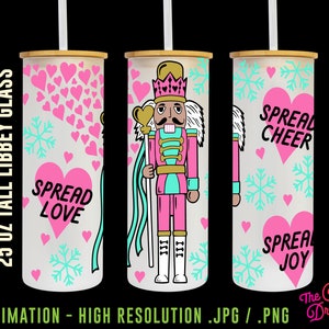 May include: Three 25 ounce tall sublimation tumblers with different designs. The first tumbler has a pink and white heart pattern with the text "Spread Love". The second tumbler has a pink and blue nutcracker design with the text "III III". The third tumbler has a pink and blue snowflake pattern with the text "Spread Cheer" and "Spread Joy".