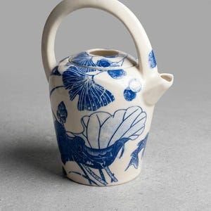 Unique tea pot decorated with underglaze transfer papper.