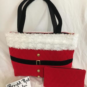 May include: A red quilted tote bag with black handles, a black belt, and gold buttons. The top edge is trimmed with white faux fur. A matching red quilted pouch is included. The text "Bright Red Combo" is on a white card.