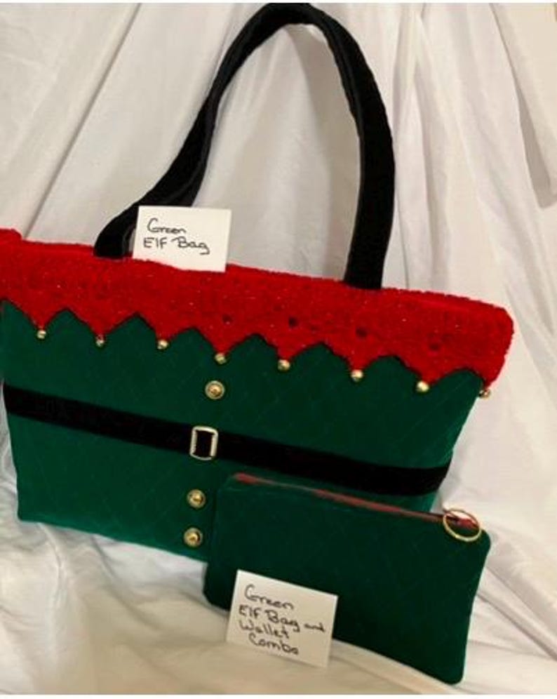 May include: A green Elf bag with a red top and black handle, and a matching green wallet. The bag has a black belt with a buckle and gold buttons. The text on the bag says "Green ELF Bag". The wallet says "Green ELF Bag and Wallet Combo".
