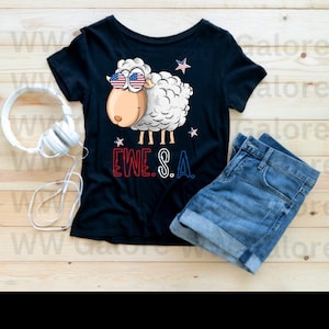 以下が含まれることがあります： アメリカの旗のデザインの入ったサングラスをかけた、漫画の羊が描かれた黒いTシャツ。羊は白く、赤い鼻と黒い目。羊の下に「EWE.S.A.」という文字が印刷されている。