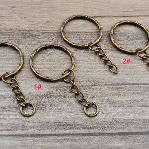 May include: Three antique gold keychains with different sized rings and chains. The keychains are labeled 1#, 2#, and 3#.