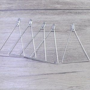 May include: Five silver triangle-shaped wire hoops, each with a small loop at the top.
