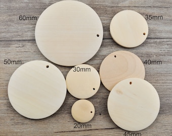 May include: Assortment of eight unfinished wooden circles in various sizes, ranging from 20mm to 60mm in diameter. Each circle has a small hole drilled in the center.