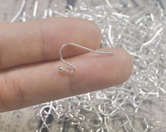 May include: Silver earring hooks with a small ball at the end. The hooks are bent into a U-shape.