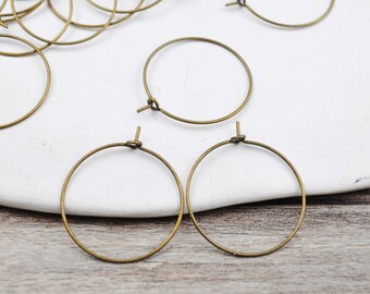 May include: A set of 10 gold-toned metal hoop earrings. The hoops are simple and circular, with a slightly textured finish.