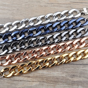 May include: Five different coloured metal chain straps with silver clasps. The chains are silver, dark blue, black, rose gold, and gold. The chains are numbered 1 through 5.