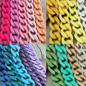 Puede incluir: Una colección de eslabones de cadena de plástico gruesos en varios colores, incluidos rojo, rosa, amarillo, azul, verde y gris. Las cadenas están dispuestas en filas, mostrando los diferentes colores y texturas.