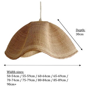 May include: A natural woven pendant light with a curved, asymmetrical shape. The light is 30 inches deep and has a width range of 20 to 36 inches.