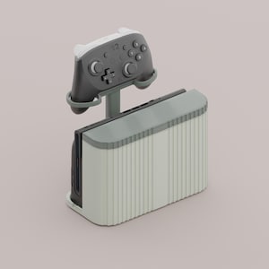 May include: A light grey and white gaming console with a matching controller. The console has a vertical design with a ribbed texture. The controller is mounted above the console, showcasing its buttons and joysticks. The design is modern and minimalist.