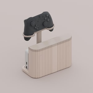 May include: A beige gaming console stand with a matching controller holder. The stand has a ribbed design and supports a dark grey controller. The design is minimalist and modern, suitable for a gaming setup.