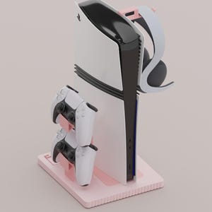 May include: A white ceramic mug with a black handle and the text "But First, Coffee" in a bold, black font. The mug is set against a blurred background. The mug appears to be approximately 10 cm tall.