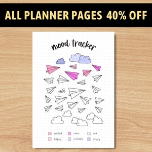 May include: A printable mood tracker page with a dotted background. The page features a title "Mood Tracker" with clouds and paper airplanes. The page includes a key with six different emotions: excited, happy, calm, irritable, sad, and angry.