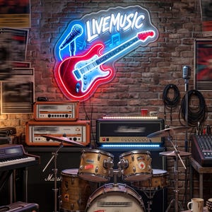 May include: A neon sign with the words "LIVE MUSIC" above a red and blue guitar and microphone. The sign is mounted on a brick wall. The image also shows a drum set, amplifiers, and a mixing board.