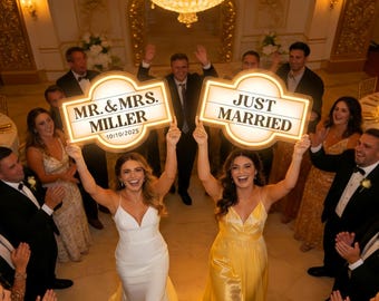 May include: Two illuminated rectangular signs with rounded corners held aloft. The left sign reads MR. & MRS. MILLER 10/10/2025 in black text. The right sign reads JUST MARRIED in black text. Both signs feature a warm white glow and dark borders.