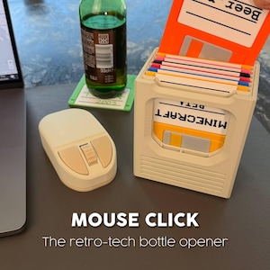 May include: A retro-tech bottle opener shaped like a computer disk drive, with a beige mouse and a green beer bottle. The opener has a slot for the disk and the text "MINECRAFT" on the front. The text "MOUSE CLICK" is also visible.