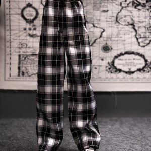 May include: Black and white plaid pants with a wide leg.
