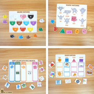 May include: A set of four educational activity mats for children. The mats feature colorful images and text, including "Colors Matching", "Shapes Matching", "Sort Colors with Real Objects", and "Shape Sorting".