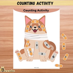 以下が含まれることがあります： 漫画の犬のイラスト、包帯、数字が描かれたカウントアクティビティシート。「COUNTING ACTIVITY」と「Counting Activity」の文字が表示されます。数字付きの包帯の切り抜きが別々に含まれています。