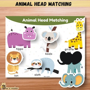 May include: A wooden educational puzzle board with the text "ANIMAL HEAD MATCHING" and "Animal Head Matching". The puzzle features colorful animal head cutouts including a hippo, koala, giraffe, lion, sloth, and elephant.