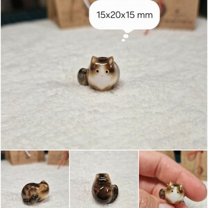Brown tabby cat loaf figurine with yellow eyes. If you would like to change the eye color of the Brown with White tabby cat figurine to green, please select the "Eyes/Nose Changes" option.