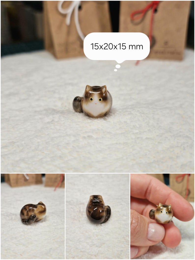 Brown tabby cat loaf figurine with yellow eyes. If you would like to change the eye color of the Brown with White tabby cat figurine to green, please select the "Eyes/Nose Changes" option.