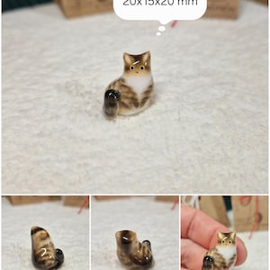 Sitting Brown tabby cat figurine with yellow eyes. If you would like to change the eye color of the Brown with white tabby cat figurine to green, please select the "Eyes/Nose Changes" option.