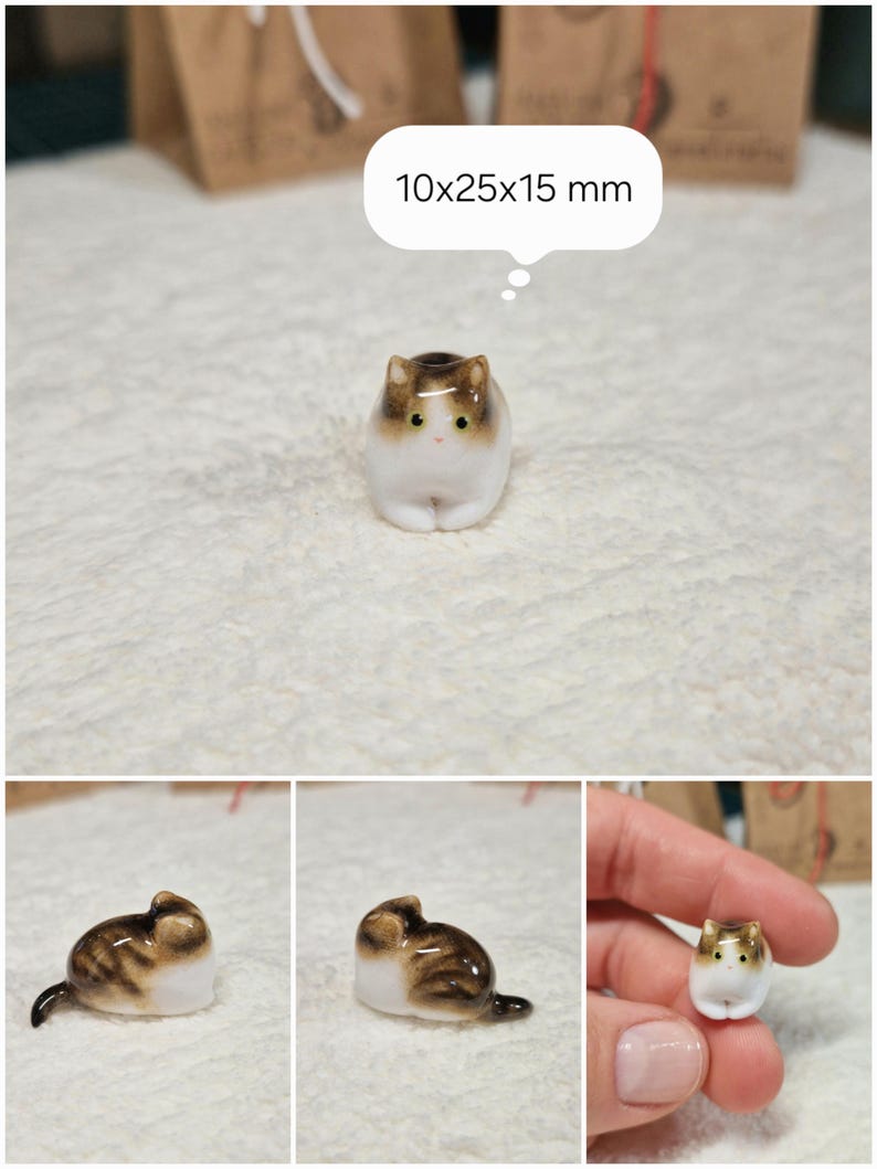 Laying down Brown tabby cat figurine with yellow eyes. If you would like to change the eye color of the Brown with White tabby cat figurine to green, please select the "Eyes/Nose Changes" option.