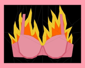 May include: A pink bra with yellow and orange flames around it. The bra is made of fabric and has a simple design.