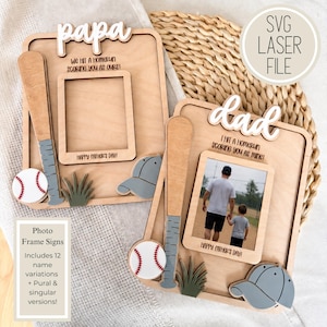 Peut inclure: Panneaux de cadre photo en bois avec des décorations sur le thème du baseball. Un cadre dit "papa" et l'autre dit "dad". Chaque cadre a une batte de baseball, une balle de baseball et une casquette de baseball. Le cadre "dad" comprend une photo. Le texte sur les cadres se lit comme suit : "Nous avons réussi un home run en vous marquant comme les nôtres !" et "J'ai réussi un home run en vous marquant comme le mien !"
