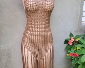 May include: A brown crochet halter top with a fringe hem. The top is made of a lightweight, breathable material and is perfect for layering or wearing on its own.
