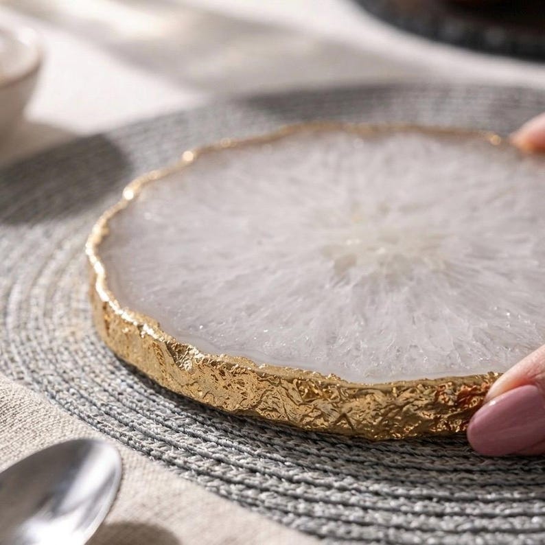 Macro close-up of natural white quartz agate slice coaster showing cloudy crystal texture and heavy gold electroplated edge
