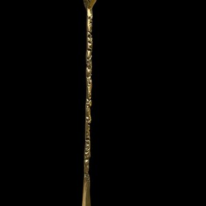 May include: A long, slender brass shoehorn featuring a detailed animal head handle at the top. The shaft of the shoehorn has a textured, organic surface, while the bottom end is smooth, polished, and curved to assist with sliding a foot into a shoe.