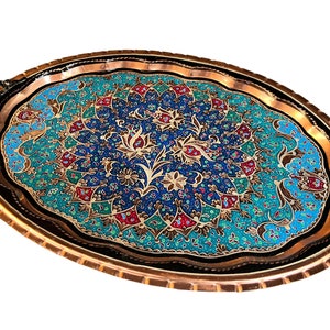 May include: An oval copper serving tray with intricate floral designs in shades of blue, green, red, and gold. The tray has two handles on the sides.