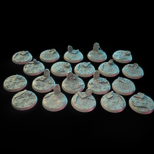 May include: A set of 20 gray plastic miniature bases with various sculpted details, including tombstones, crosses, and other graveyard elements. The bases are designed for tabletop gaming or miniature display.