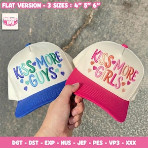 May include: Two baseball caps with white crowns and colored brims. The left cap has a blue brim and blue and green embroidery reading KISS MORE GUYS with small hearts. The right cap has a pink brim and pink and orange embroidery reading KISS MORE GIRLS with small hearts. Text reads FLAT VERSION - 3 SIZES : 4" 5" 6" and DGT - DST - EXP - HUS - JEF - PES - VP3 - XXX.