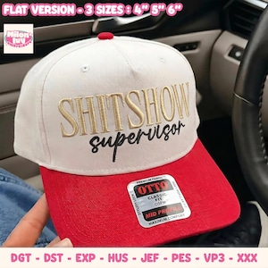 May include: A white baseball cap with a red brim and a red top button. The front features gold embroidered text reading SHITSHOW and black embroidered text reading supervisor. A sticker on the brim displays OTTO CLASSIC FIT OSFM.