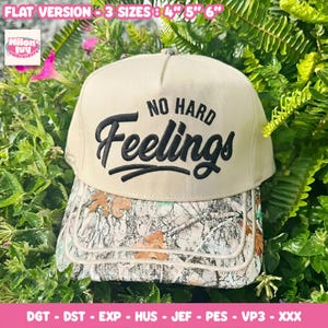 May include: A beige baseball cap featuring the embroidered black text NO HARD Feelings on the front crown. The brim displays a camouflage pattern with brown oak leaves and grey branches. The text FLAT VERSION - 3 SIZES 4" 5" 6" is visible.