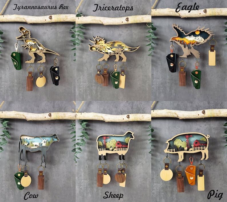 May include: Six wooden keychains with different animal designs. Each keychain has a small leather pouch and a metal ring. The animals are a Tyrannosaurus Rex, a Triceratops, an eagle, a cow, a sheep, and a pig.