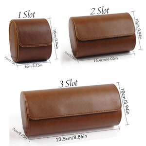 May include: Three brown cylindrical watch cases labeled 1 Slot, 2 Slot, and 3 Slot. The 1 Slot case measures 3.15 inches by 3.94 inches by 2.75 inches. The 2 Slot case is 6.05 inches by 3.94 inches by 2.75 inches. The 3 Slot case is 8.86 inches by 3.94 inches by 2.75 inches.