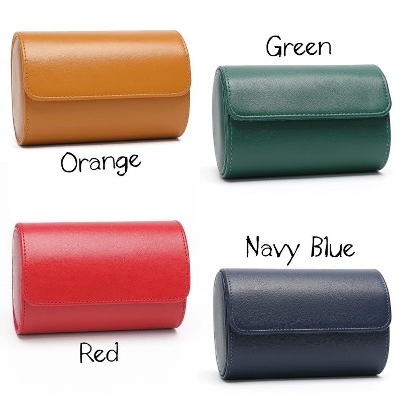 May include: Four cylindrical watch cases with a smooth finish and a flap closure. The colors are orange, green, red, and navy blue. Each case is labeled with its respective color name in black text: Orange, Green, Red, and Navy Blue.