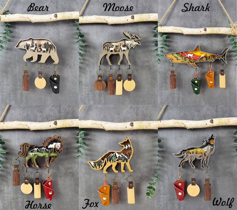 May include: Wooden keychains featuring various animals, including a bear, moose, shark, horse, fox, and wolf. Each keychain has a detailed design with a nature scene inside the animal silhouette. The keychains come with a variety of leather key holders in different colors.