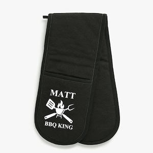 May include: Black oven mitts with a white pocket and the text "MATT BBQ KING" with a grill, spatula, and tongs graphic.